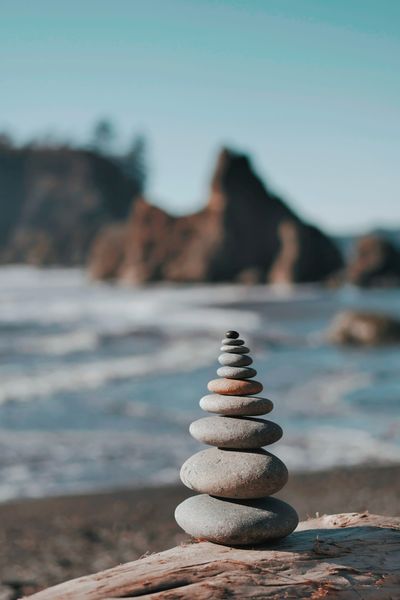Smooth stones balanced in a stack on a beach
